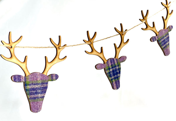Garland of stags in wood and tartan purples and greens