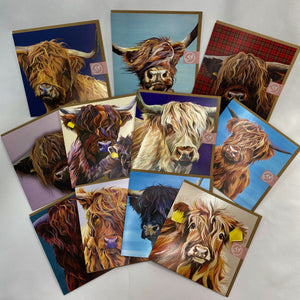 Selection of colourful greetings cards with different highland cow designs